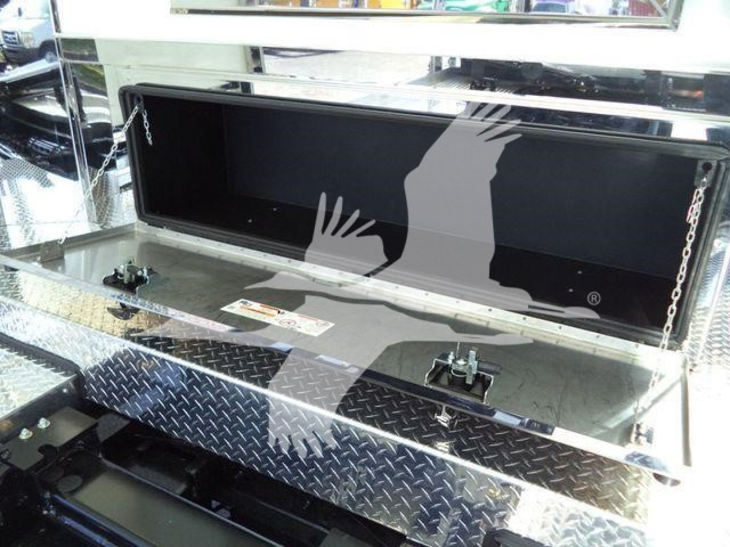 Kenworth T280 rollback bed toolbox open showing aluminum diamond plate step and storage compartment.