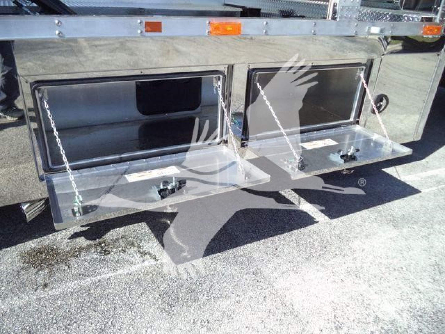 Kenworth T280 rollback truck side compartments with two chrome toolbox doors and chains visible.