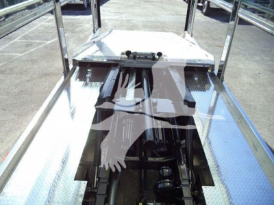 Truck bed/storage platform showing chrome railing and Diamond plate diamond-metal surface on trailer/rollback unit for a 2025 Kenworth T280.