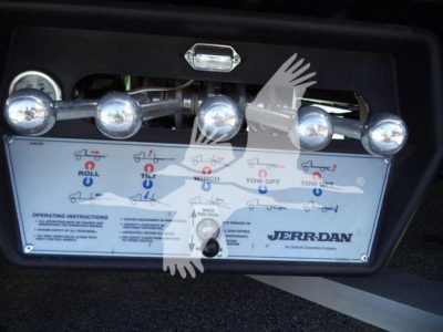 Kenworth T280 rollback control panel with multiple knobs and levers labeled for roll, tilt, winch, tow, and JERR-DAN branding.