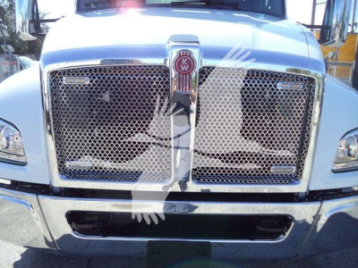 Kenworth T280 front grille and chrome bumper with KW emblem, truck head-on view in a dealership lot.