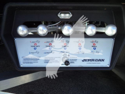 Kenworth rollback control panel with four toggle levers and labeled indicators; JERR-DAN branding on control box.