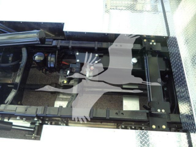 Kenworth T280 rollback truck chassis frame and mounting area visible, with hydraulic lines and suspension components.