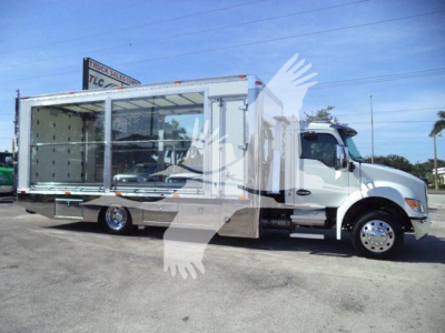 Kenworth T280 rollback truck with open cargo area side view showing cab and aluminum cargo body.