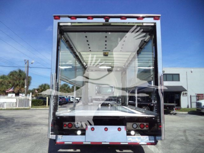 Kenworth truck rollback bed with open rear doors, showing interior cargo area and rear lights; no legible labels visible in image.
