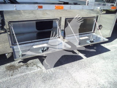 Kenworth T280 rollback truck side compartments with two chrome toolbox doors and chains visible.