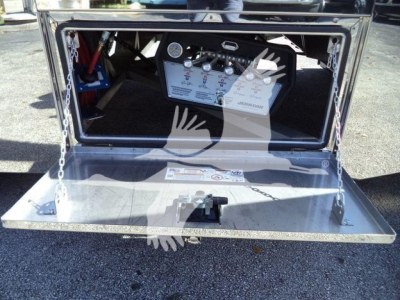 Kenworth T280 rollback truck toolbox open showing control panel and metal platform with safety chains and label text.