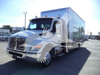 Kenworth T680 or similar cargo sleeper truck in white with a large enclosed box body, front chrome grille, bumper, and dual rear wheels; visible text not legible.