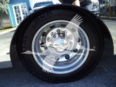 Wheel, tire, and polished chrome hub shown on Kenworth T280 rollback truck front wheel.