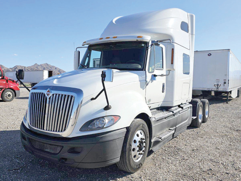 Truck cab showing International LT Series badge and grill with dual fuel/air tanks, side mirrors, and sleeper cab. Text on the listing includes VIN 3HSDZAPRXMN148646 and stock number 548887.
