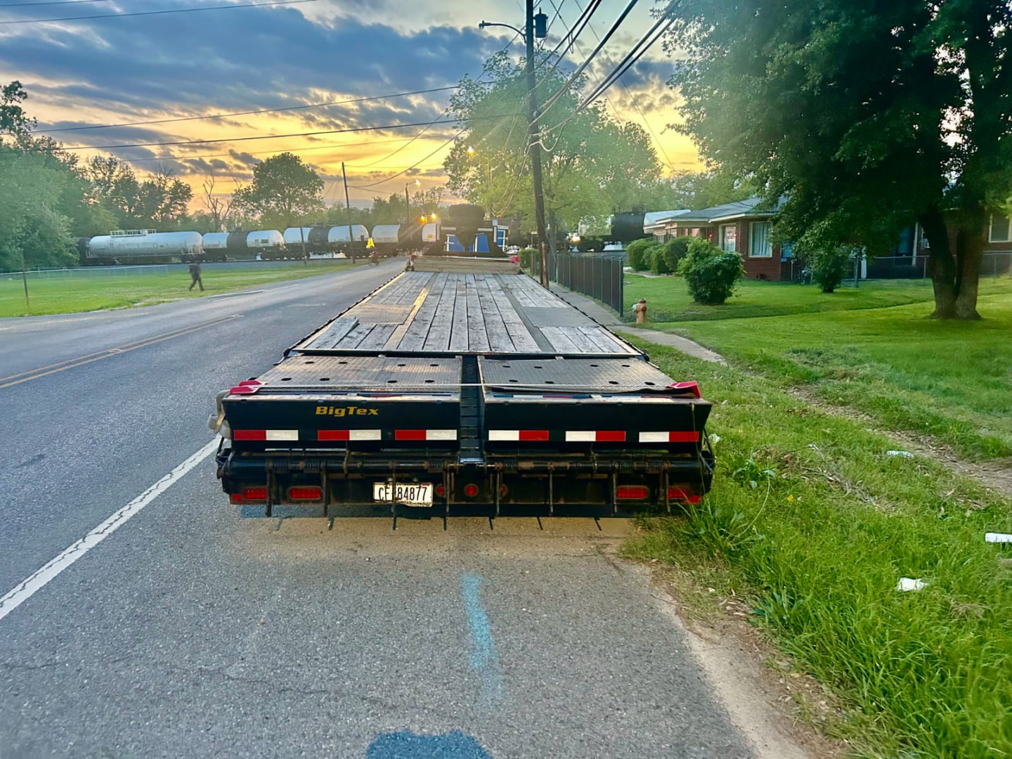 Big Tex flatbed trailer showing rear view with wooden deck and taillights.