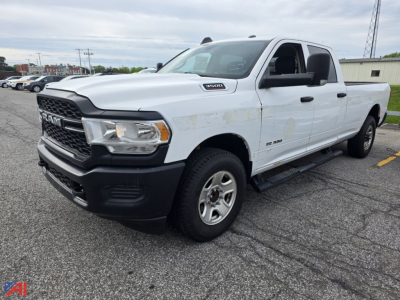 Ram 3500 pickup truck in white, front three-quarter view showing crew cab, long bed, and badge on fender.