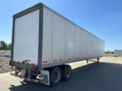 Trailer side and rear of a 2014 Wabash van trailer with white opaque panels, dual rear axles, and a license plate/permit sign visible at rear.