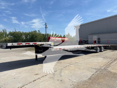 Transcraft D-Eagle II drop deck trailer showing flatbed with dual rear axles and gooseneck to the left.