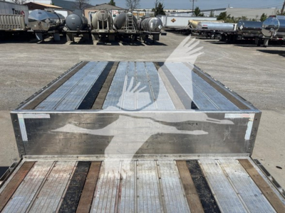 Transcraft D-Eagle II trailer deck showing metal surface and wooden planks with side rails.