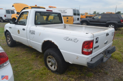 Ford Ranger pickup truck 4x4 rear-side view showing tailgate and bed with visible rust patches and wheelchair? (Note: image shows a white 2008 Ford Ranger with rear bumper damaged, pickup bed, and rust spots)