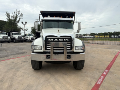 Mack GR64F dump truck front view showing chrome grille with MACK emblem and bumper guard.