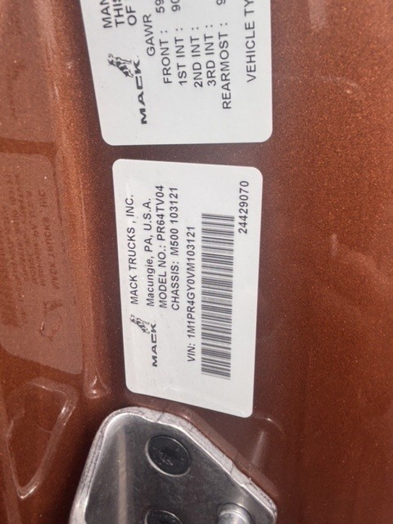 Mack truck door jamb labels showing VIN and stock number information.