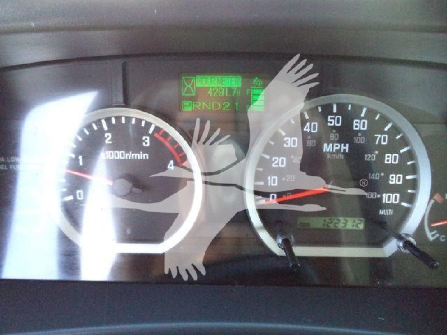 Isuzu NPR XD dashboard showing speedometer and tachometer with green diagnostic display and odometer reading.