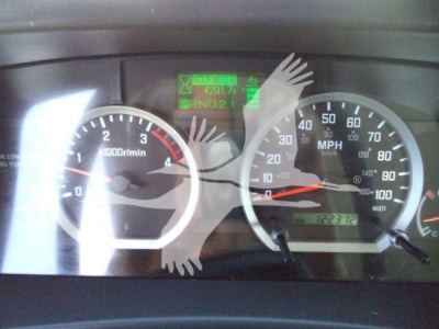 Isuzu NPR XD dashboard showing speedometer and tachometer with green diagnostic display and odometer reading.