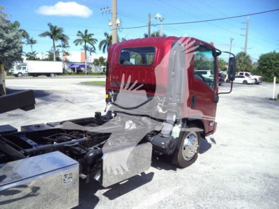 Isuzu NPR XD truck cab and chassis in rollback configuration with red cab and exposed frame showing hydraulic components.