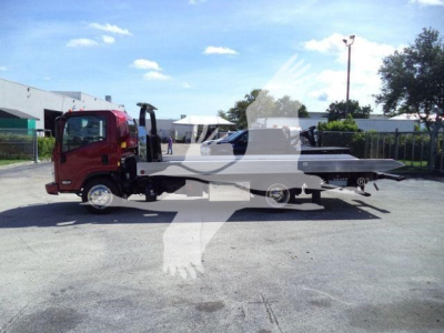Isuzu NPR XD rollback truck side view showing flatbed and cab with red exterior.