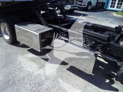 Isuzu NPR XD chassis showing two metallic storage boxes attached under the frame and exposed frame rails.