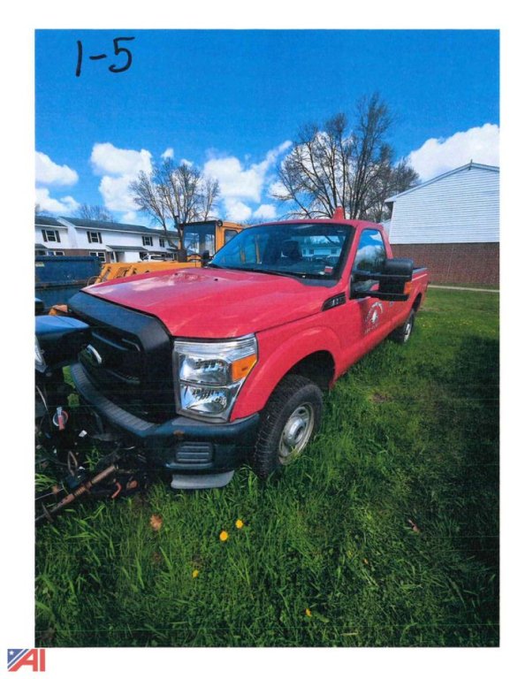 Truck showing red 2011 Ford F-250 Super Duty with plow attachment in front, grassy lot, blue sky.