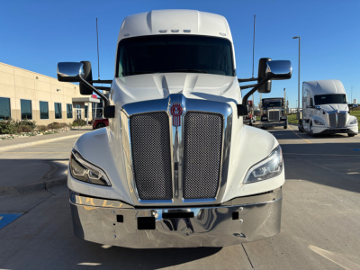 Kenworth T680 front view showing chrome grille, headlights, large bumper, and tall aerodynamic hood with Kenworth emblem.