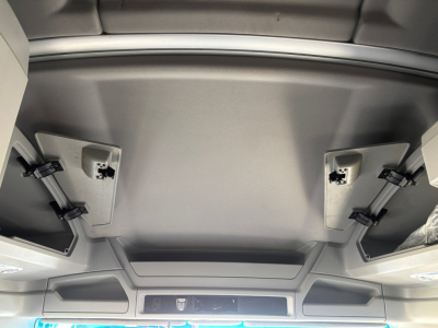 Kenworth T680 truck interior ceiling hatch area with overhead panels and air vents.