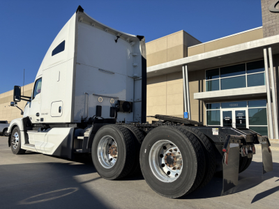 Kenworth T680 tractor side view showing left rear triple-axle with tires and sleeper cab.