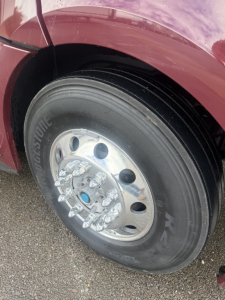 Freightliner Cascadia126 wheel/tire on front left side with polished steel rim and tire branding visible.