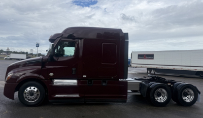 Truck side view showing Freightliner Cascadia 126 with sleeper cab and dual rear axles.