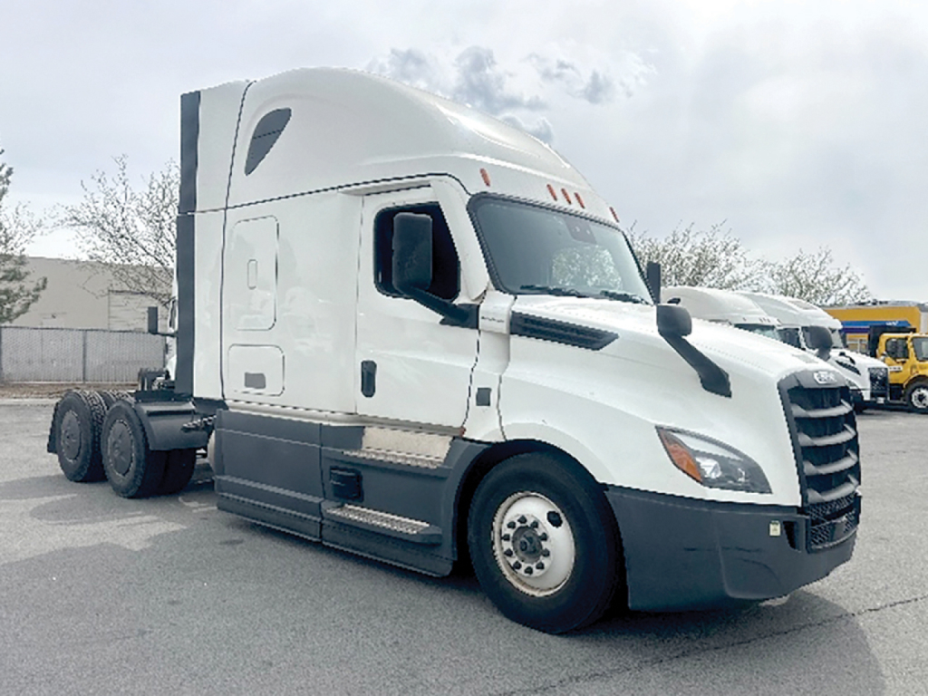 Truck front-left view of a white 2023 Freightliner Cascadia126 with sleeper cab and aerodynamic mirrors. Visible text includes no legible labels on the truck body.