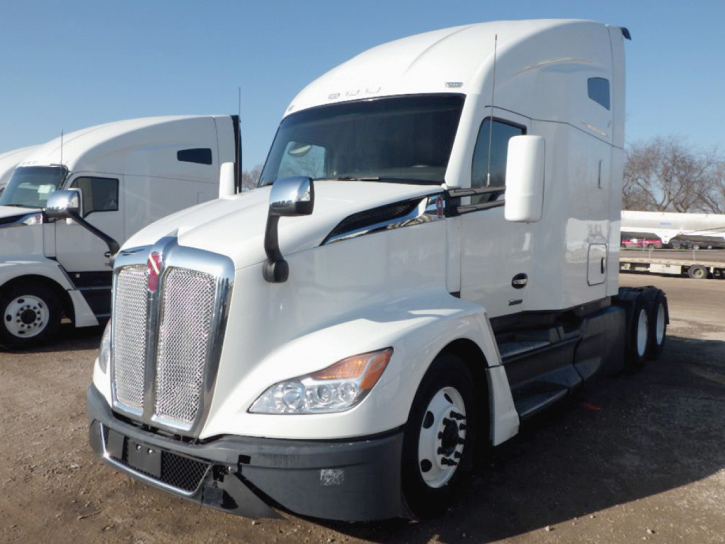 Kenworth T680 Next Gen tractor cab with sleeper, front grille, large side mirrors, and dual rear axles visible.