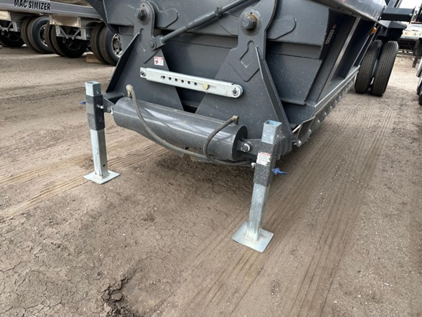 Trailer hitch legs and underside of a CPS 40' light weight air ride bottom dump trailer showing adjustable/support legs and frame details.