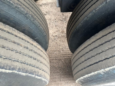 Trailer tires in a dual-axle setup with tread lines visible, part of a 2025 CPS 40' light weight air ride bottom dump trailer listing.