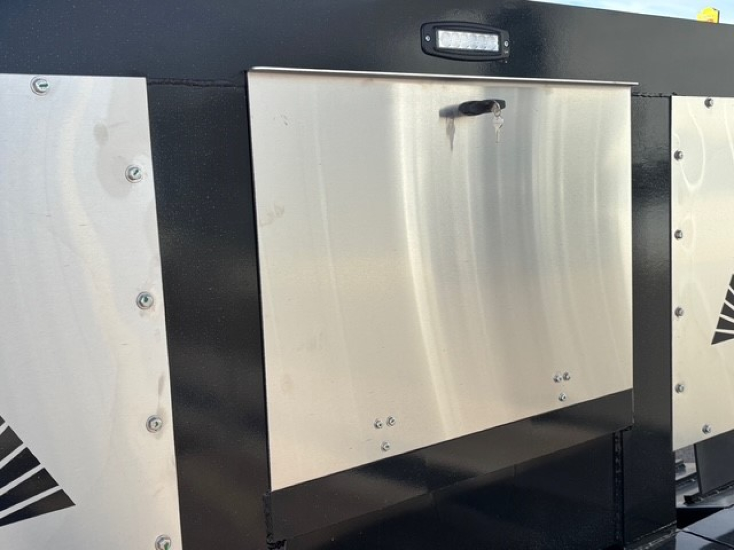 Alpha A80MG mech detach double drop trailer with swingouts showing metal access panels and weld bolts.