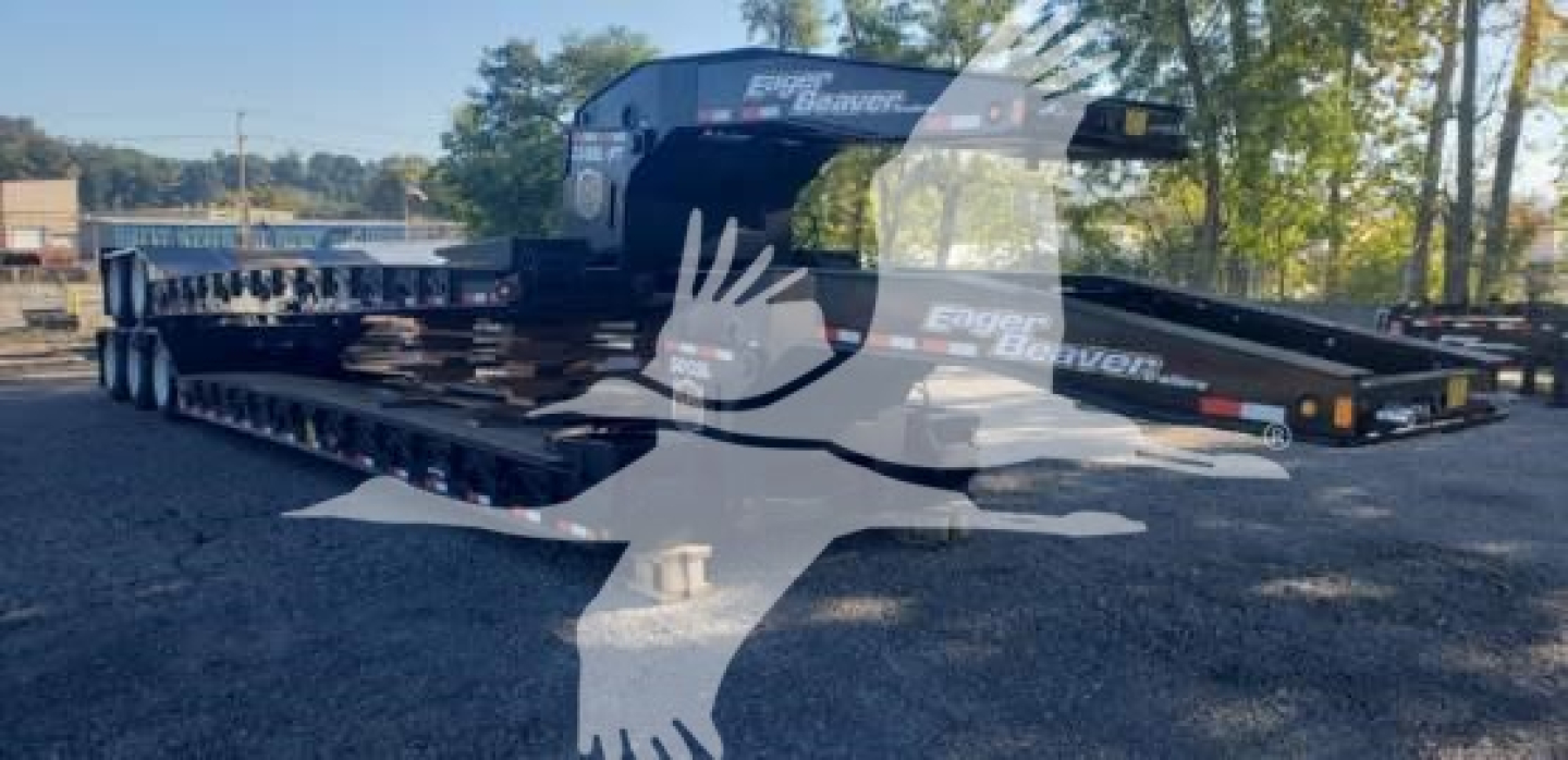 Lowboy trailer showing 2027 Eager Beaver 50Gsl-3 with long flatbed and gooseneck in yard, VL088779 stock number.