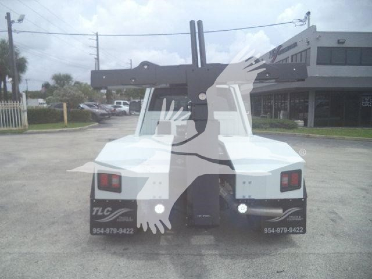 Winch-equipped 2024 Ram 4500 SLT front view with hydraulic boom arms and towing apparatus visible.