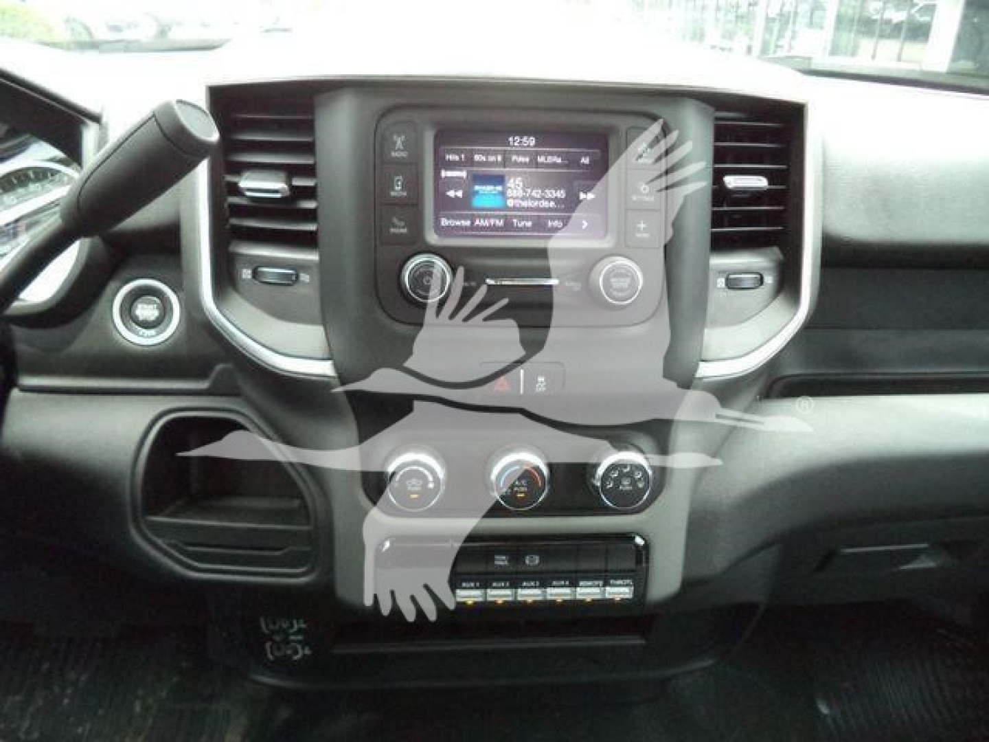 Dashboard view of a RAM 4500 interior showing central touchscreen, climate controls, and radio. Visible text includes the screen display with options and numbers but legible details are not fully clear.