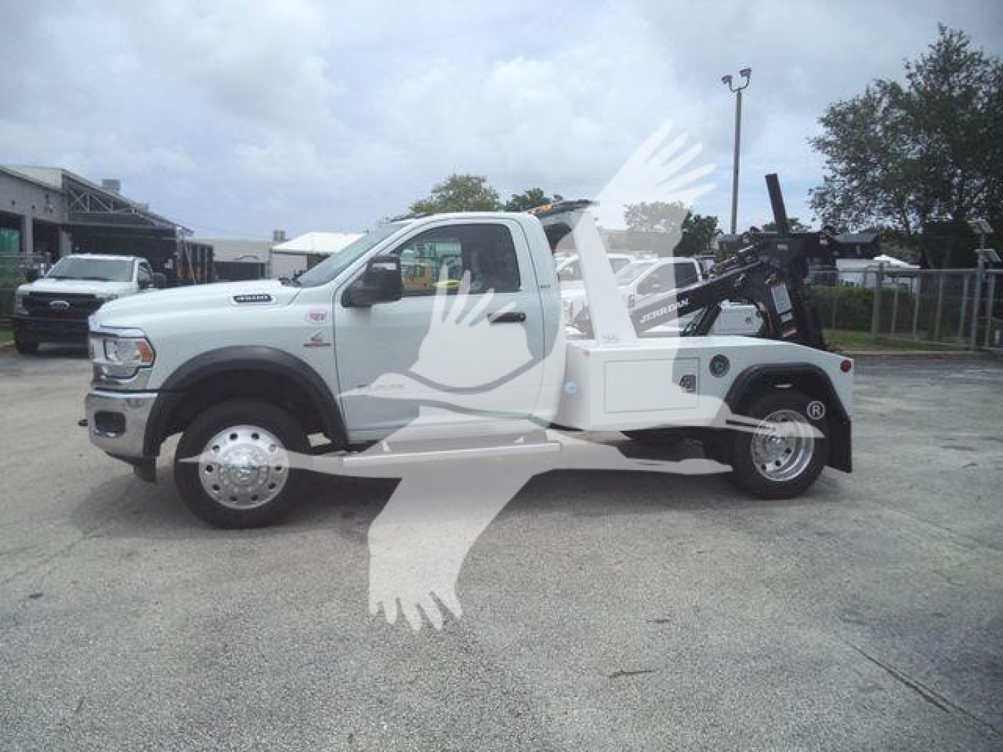 Ram 4500 SLT tow truck side view showing front cab and large integrated flatbed with winch gear and towing equipment.