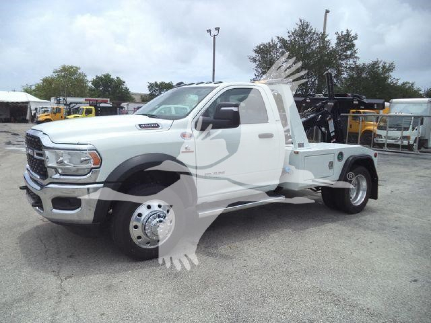 Truck body showing Ram 4500 SLT with tow/mounting rack and winch equipment in a dealership lot.