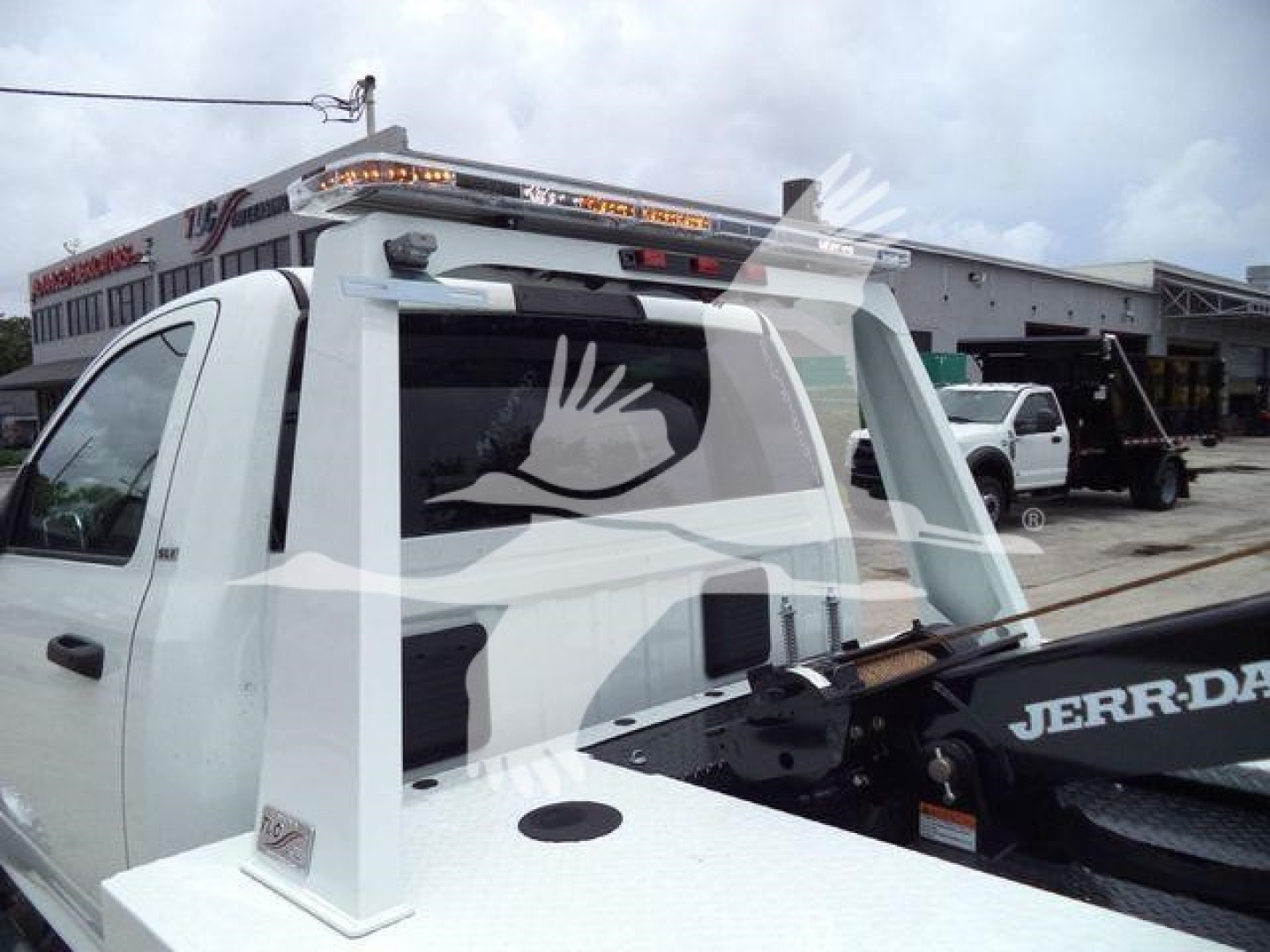 Ram 4500 SLT pickup with a winch setup and tow hitch, visible rear cab area and equipment carrier.
