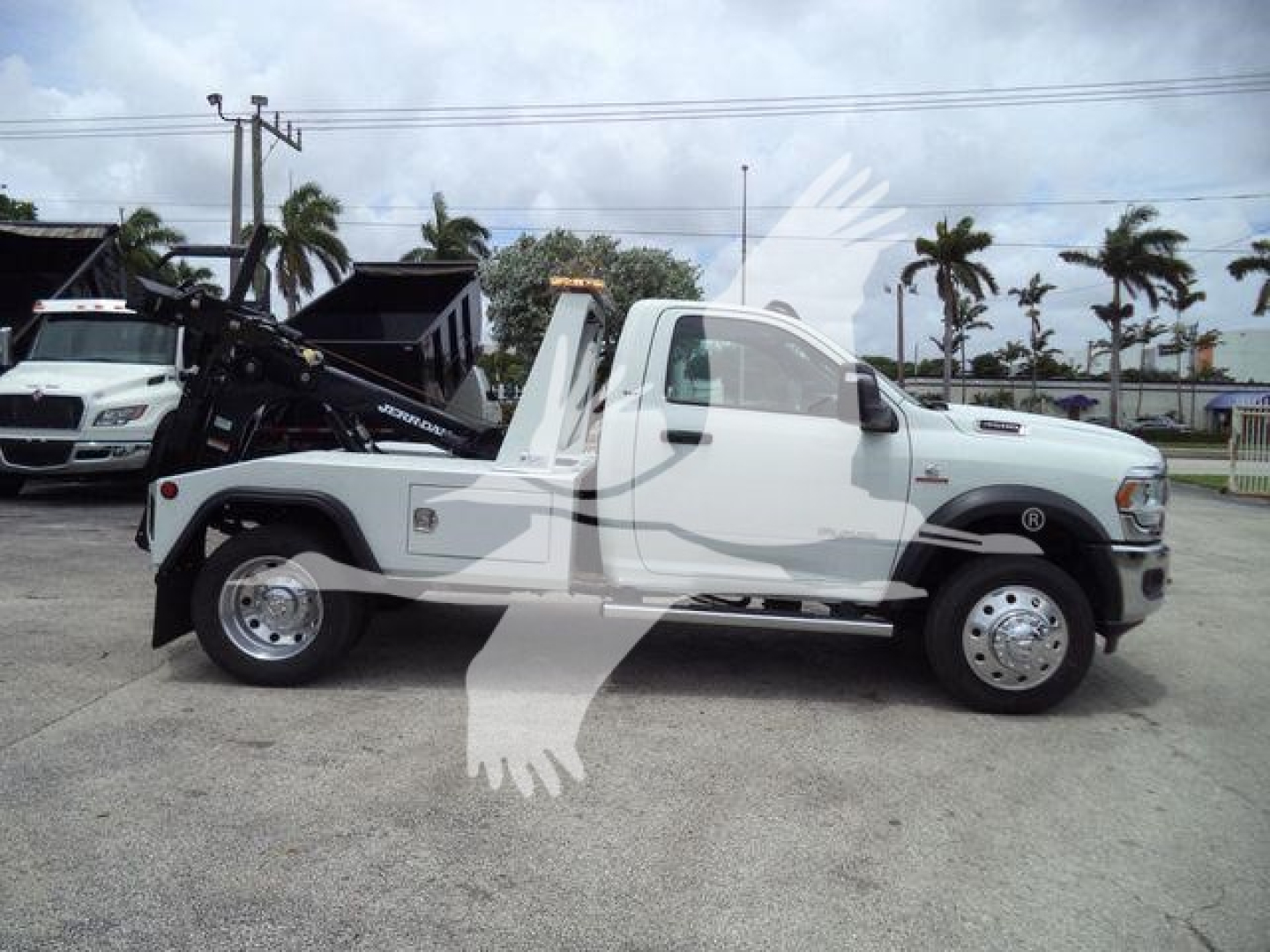 Ram 4500 tow truck side view showing single cab, white paint, wheel-lift equipment, J98294FM stock number plate.