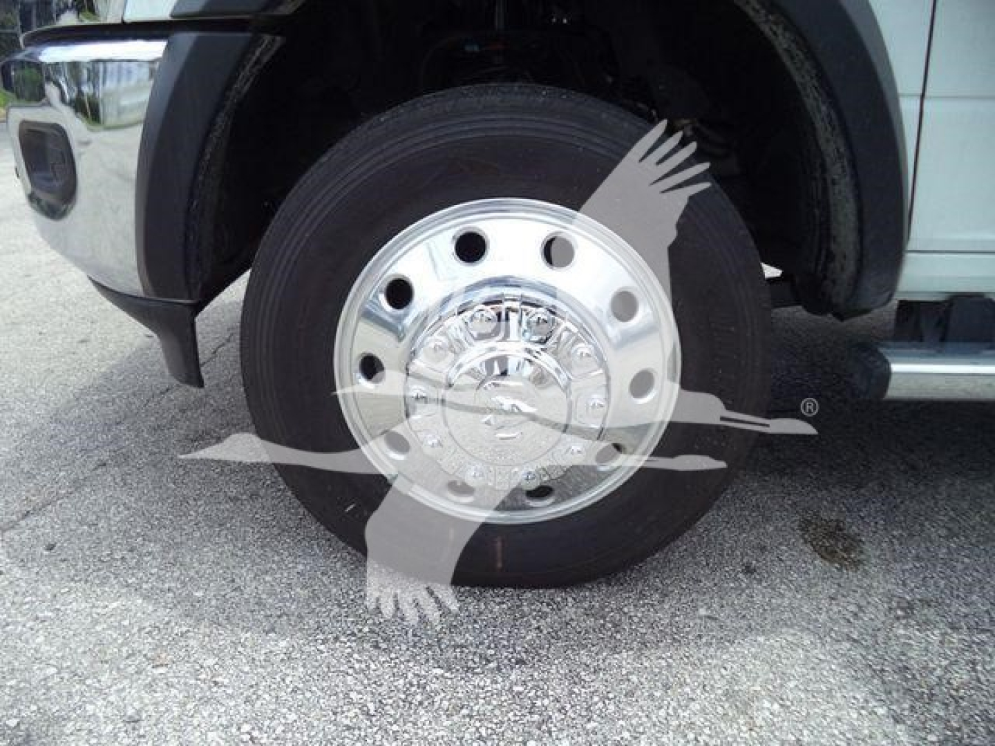 Wheel of a Ram 4500 truck with chrome hubcap and black tire. No visible text legible on tire or wheel directly.