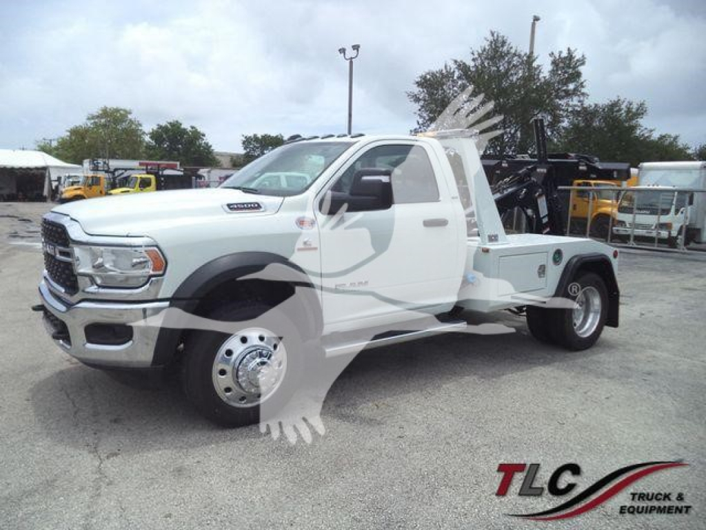 Ram 4500 tow truck with flatbed and wheel-lift, front three-quarter view showing winch equipment and service body.