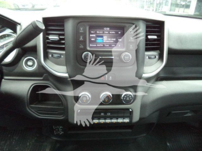 Dashboard view of a RAM 4500 interior showing central touchscreen, climate controls, and radio. Visible text includes the screen display with options and numbers but legible details are not fully clear.