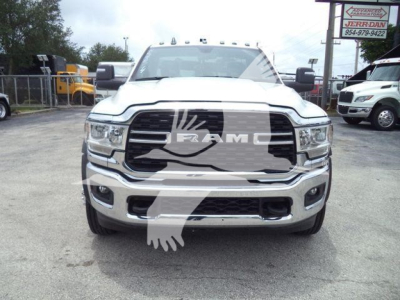 Front view of a white 2024 Ram 4500 SLT truck showing large black grille with RAM logo and chrome bumper.