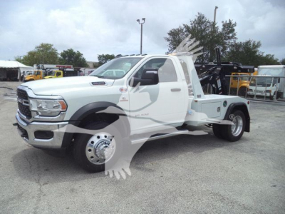 Truck body showing Ram 4500 SLT with tow/mounting rack and winch equipment in a dealership lot.